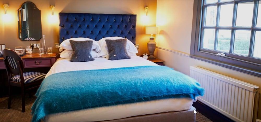 The Fleece At Сайърънсестър Екстериор снимка A bed with a blue throw